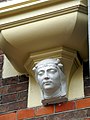 This is an image of rijksmonument number 469358 Head supporting a chimney at the southside of the Gouvernementsgebouw, a former government building (now Drents Museum) at Brink 2, Assen.