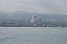 Smoke rises from IAF attacks on he Rashidieh area during the 2006 Lebanon war (from the collections of the ICRC Audiovisual Archives) ICRC-AVarchives-TyreBombings-MarkoKokic-09092006-V-P-LB-E-00260.jpg