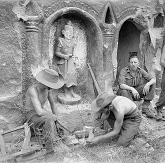 Men of the 26th Indian Infantry Division preparing a meal beside a temple on Ramree Island, January 1945. Indian Div beside temple on Ramree Island.jpg