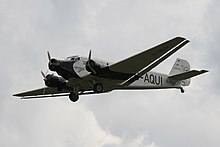 Lufthansa's 21st-century airworthy heritage Ju 52/3mg2e (Wk-Nr 5489) in flight, showing the Doppelflugel, "double wing" trailing-edge control surfaces Junkers Ju 52-3mg2.jpg