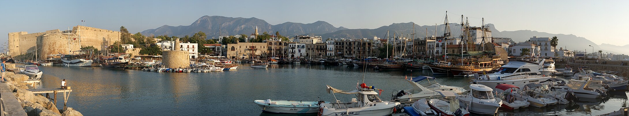 Panoramic view of the Kyrenia Harbour, with the Venetian-era Kyrenia Castle on the far left, and the Kyrenia Mountains in the background