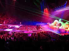 The tour stage showing the catwalks protruding into the audience Lady Gaga, ARTPOP Ball Tour, Bell Center, Montreal, 2 July 2014 (41) (14376800767).jpg