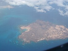 Aerial view of Lobos Island, with the harbour of Corralejo, Fuerteventura Island, in the top left corner