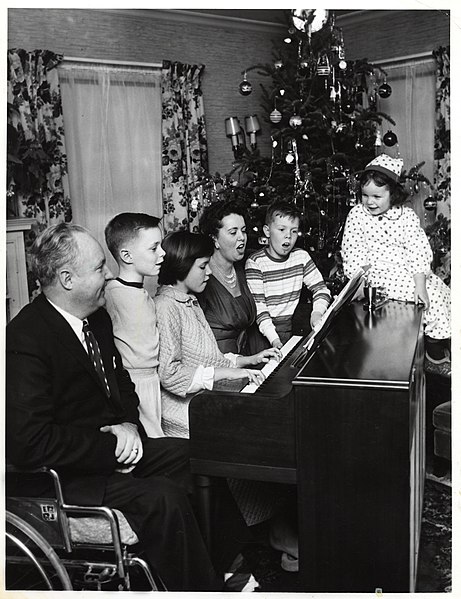 File:Mayor John F. Collins, Mary Collins, and their children, Thomas, Patricia, John, and Margaret, gathering around a piano in front of Christmas tree (10290572914).jpg