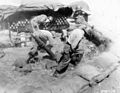 A 4.2-inch mortar crew of the Heavy Mortar Company, 179th Regiment, 45th U.S. Infantry Division, fires on Communist positions, west of Chorwon, Korea, 5 May 1952.