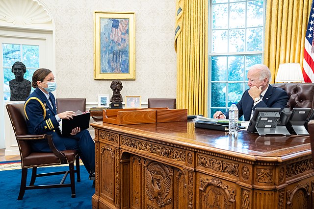 President Joe Biden meets with Coast Guard aide Lieutenant Commander Jayna McCarron about Medal of Honor recipients, Wednesday, October 6, 2021, in th