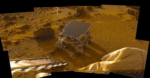 Sojourner disembarks Mars Pathfinder base station lander on the surface of planet Mars