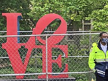 The Love statue near 36th Street and Locust Walk fenced in and guarded by Penn security. Penn security guarding the Love Statue.jpg