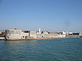 The Round Tower, Portsmouth, Hampshire, seen from the sun deck of Wightlink Wight Ryder I as it leaves Portsmouth Harbour heading to the Isle of Wight.