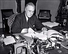 U.S. President Franklin D. Roosevelt signs the Lend-Lease bill to give aid to Britain and China (1941). President Franklin D. Roosevelt-1941.jpg