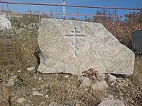 One of many religious symbols carved into stone sitting on the side of the pathway up to the mask of sorrow. This is an Eastern Orthodox cross