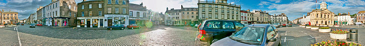 Kelso is unique in Scotland for having a cobbled square fed by four cobbled streets Stitchedkelsowiki.jpg