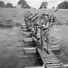 Men of the 8th Battalion, Sherwood Foresters cross a river using a small kapok pontoon bridge, Dunadry in Northern Ireland, 28 August 1941. The British Army in the United Kingdom 1939-45 H13291.jpg