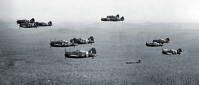 A Bristol Blenheim Mark IV (lower right) accompanies a squadron of Brewster Buffaloes over the Malayan jungle, late 1941.