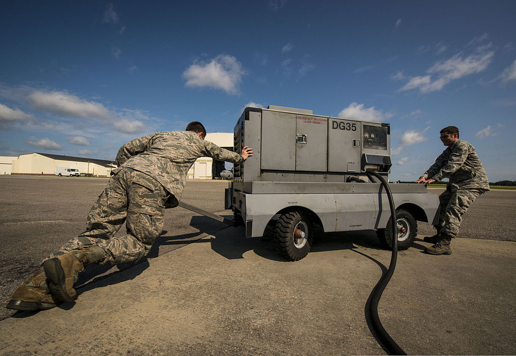 File:U.S. Air Force Tech. Sgt. Jonathan Livingston, right, and Senior Airman Clayton Valentine, jet specialists with the Maintenance position a generator before connecting it to C-17 130626-F-LR006-011.jpg -