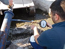 Measuring hydraulic head in an artesian aquifer, where the water level is above the ground surface USGS-Armenia, March 2, 2016, Ararat Valley 05.jpg