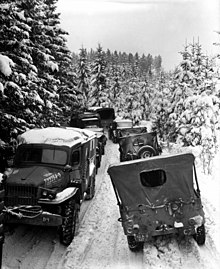 Vehicles of the U.S. 87th Infantry Division in the woods near Wallerode/St. Vith, Belgium, on 30 January 1945. US 87th ID vehicles StVith Jan1945.jpeg
