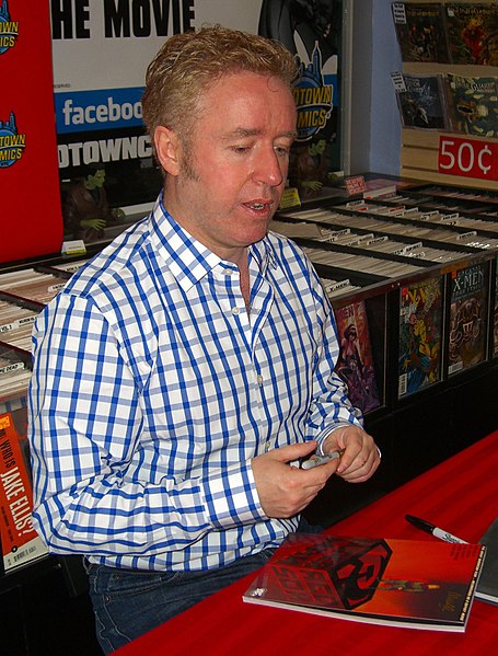 Millar signing a copy of Superman: Red Son at Midtown Comics in Manhattan