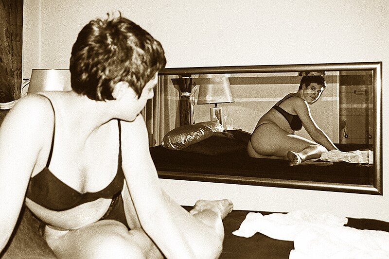 File:59120145 Woman lying on bed, looking at mirror, Berlin 2001-5.jpg