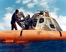 A U.S. Navy diver helps Mitchell out of the Command Module, 1971