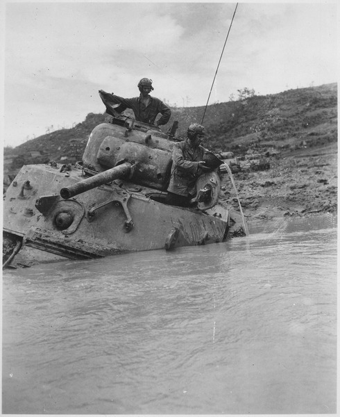 File:A tank sunk in 5 feet of water waits for towing equipment. The Tank Commander gives vent to his feelings with a... - NARA - 531305.tif