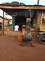 A woman carrying water on the head in Northern Ghana