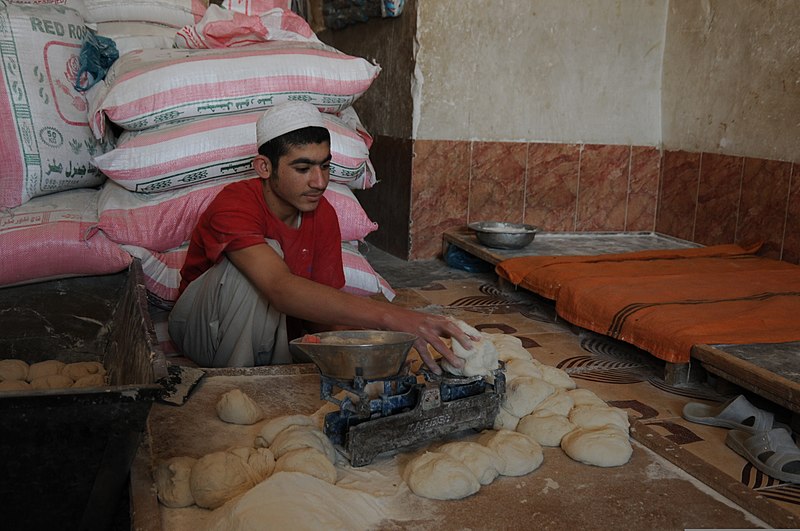 File:An Afghan boy weighs dough while preparing naan for sale in Farah, Afghanistan, April 3, 2013 130403-N-LR347-114.jpg