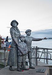 Statue on the waterfront of Annie Moore and her brothers.  Annie Moore was the first person to be admitted to the United States of America through the new immigration centre at Ellis Island, New York on 1 January 1892.