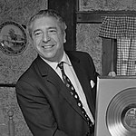 Mantovani (pictured in 1970) had three top 10 singles in 1953, including chart-topper "The Song from Moulin Rouge". Annunzio Paolo Mantovani (1970).jpg