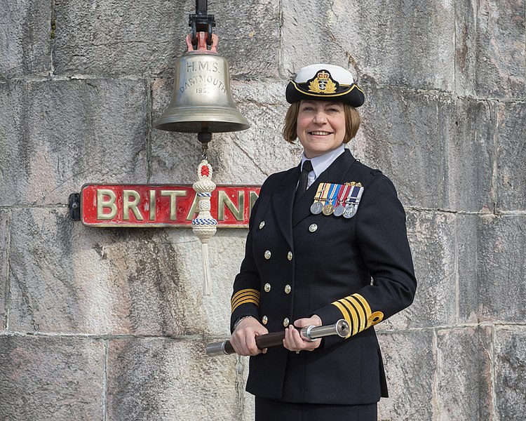 File:BRNCs new CO Captain Sarah Oakley in front of the colleges famous bell.jpg