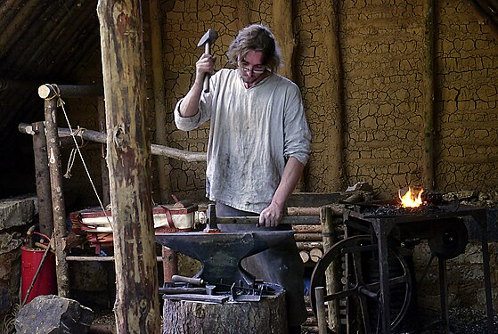 Blacksmith at the reconstruction side of a medieval monastry ("Campus Galli") in Southern Germany