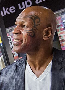Tyson's face tattoo, photographed in 2013 BoxingHallOfFame 6 MikeTysonadmiringaMuhammadAliRobe cropped.jpg