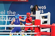 Deutsch: Boxen bei den Olympischen Jugendspielen 2018 Tag 12, 18. Oktober 2018 - Finale Fliegengewicht Mädchen – Martina La Piana (Italien, blau) schlägt Adijat Gbadamosi (Nigeria, rot) 5-0; Ringrichter ist James Beckles (Trinidad und Tobago). English: Boxing at the 2018 Summer Youth Olympics on 18 October 2018 – Girl's flyweight Gold Medal Bout - Martina La Piana (Italy, blue) beats Adijat Gbadamosi (Nigeria, red) 5-0; Referee is James Beckles (Trinidad and Tobago). Español: Boxeo en los Juegos Olímpicos Juveniles de Verano de 2018 en 18 de octubre de 2018 - Combate a medalla de oro de peso mosca para mujeres: Martina La Piana (Italia, azul) le gana a Adijat Gbadamosi (Nigeria, roja) 5-0; El árbitro es James Beckles (Trinidad y Tobago).