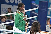 Deutsch: Boxen bei den Olympischen Jugendspielen 2018 Tag 12, 18. Oktober 2018 - Medaillenzeremonie im Fliegengewicht der Mädchen - Gold: Martina La Piana (Italien), Silber: Adijat Gbadamosi (Nigeria), Bronze: Heaven Destiny Garcia (USA); Medaillenübergabe durch Habu Gumel (IOC, Nigeria), Geschenkübergabe durch Dr. Joseph O. Ayeni (Nigeria, AIBA). English: Boxing at the 2018 Summer Youth Olympics on 18 October 2018 – Girl's flyweight Medal Ceremony - Gold: Martina La Piana (Italy), Silver: Adijat Gbadamosi (Nigeria), Bronze: Heaven Destiny Garcia (USA); Medal handover by Habu Gumel (IOC, Nigeria), Gift presented by Dr. Joseph O. Ayeni (Nigeria, AIBA). Español: Boxeo en los Juegos Olímpicos Juveniles de Verano de 2018 en 18 de octubre de 2018 - Ceremonia de la Medalla de peso mosca para niñas - Oro: Martina La Piana (Italia), Plata: Adijat Gbadamosi (Nigeria), Bronce: Heaven Destiny Garcia (Estados Unidos); Entrega de medallas por Habu Gumel (COI, Nigeria), Regalo presentado por Joseph O. Ayeni (Nigeria, AIBA).