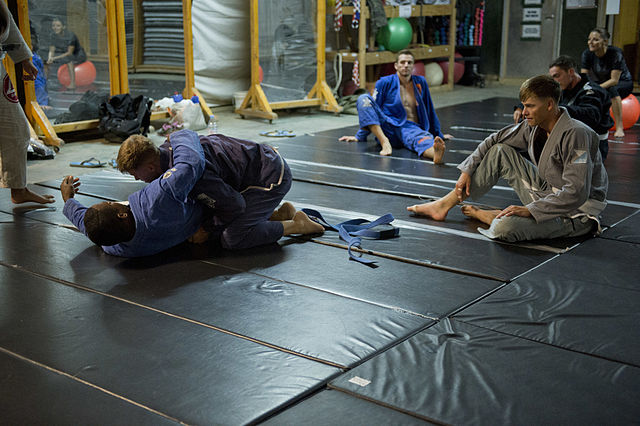 A Brazilian jiu-jitsu instructor demonstrates how to tackle an opponent.