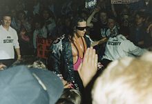 For his entrances, Hart often wore a leather jacket with shoulder tassels (epaulets), Mylar wrap-around (originally silver, later pink) sunglasses and bright pink attire[47]