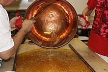 Heated syrup being poured onto a cooling table