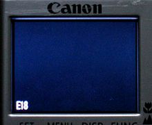 The E18 error as it appears on a camera's LCD display (an Ixus II in this example). Canon Ixus II with E18 error.jpg