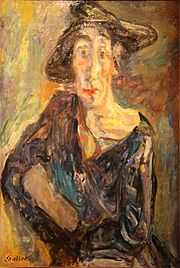 Figure féminine de face, au visage allongé, coiffée d'un chapeau sans forme et vêtue d'une robe sombre mal ajustée