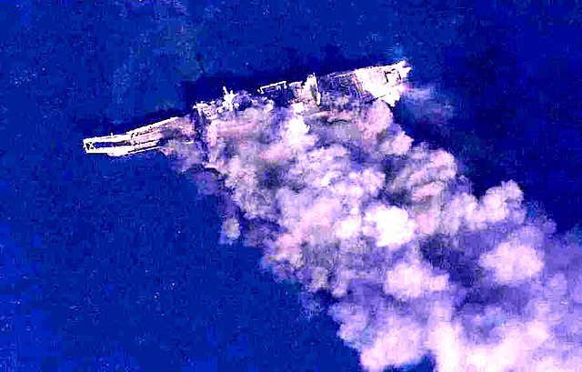Ex-La Moure County overhead view showing the ship later in the SINKEX exercise, burning after several missile hits