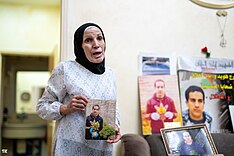 Eyad al-Hallaq's mother with his pictures