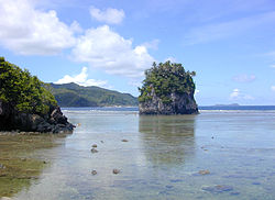 Bebatuan atau pulau kecil Fatu (kanan, juga disebut Batu Menara dan Pot Bunga) dan Futi (kiri) di terumbu Tutuila