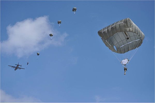 Students jump from a C-130 using T-11 parachutes during the Airborne School's final week of training.