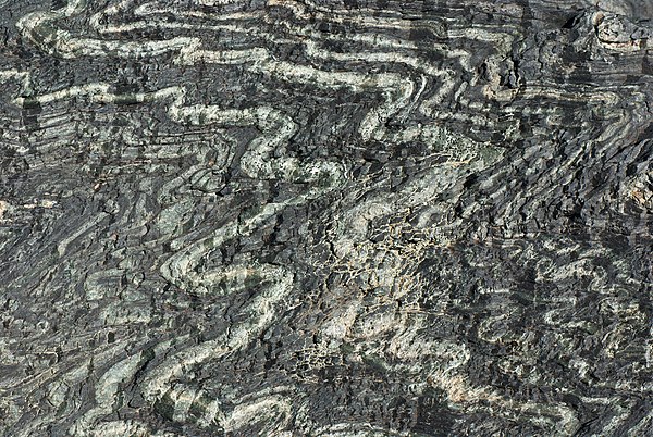 Tightly folded serpentinite from the Tux Alps, Austria. Closeup view about 30 cm × 20 cm (11.8 in × 7.9 in).