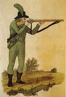 A British rifleman firing a Baker rifle (engraving from an 1803 book by Ezekiel Baker, designer of the rifle) Green jacketed rifleman firing Baker rifle 1803.jpg