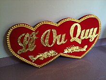 Vietnamese sayings of good fortune and a happy marriage for the couple are seen in many wedding decorations. Le Vu Quy wedding decoration.JPG