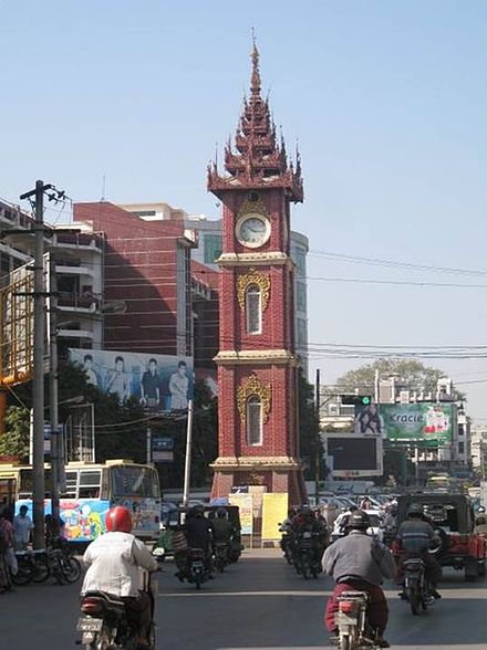 A busy street scene in Mandalay, with the clock tower built to commemorate Queen Victoria's diamond jubilee.