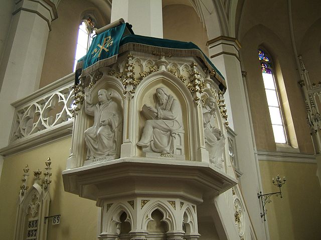 Two central figures of the Protestant Reformation, Martin Luther and John Calvin, depicted on a church pulpit; both Luther and Calvin emphasized makin