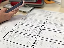 User experience designer sketching out new design for a phone app New23762.jpg