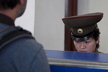 North Korean customs officer at Pyongyang Sunan International Airport. North Korea - Sunan Airport (5194926935).jpg